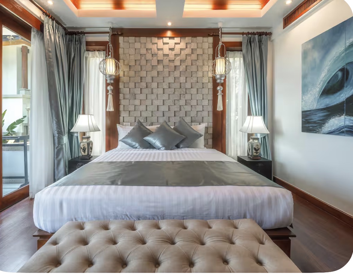 Bedroom with a king bed, stone headboard and balcony doors