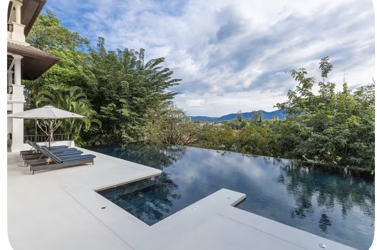 Sunset over a luxury villa infinity pool in Phuket